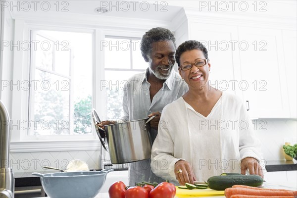 Senior couple cooking in kitchen