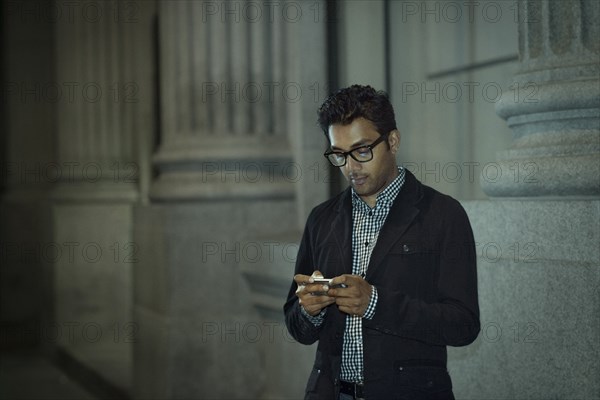 Man using cell phone on city street