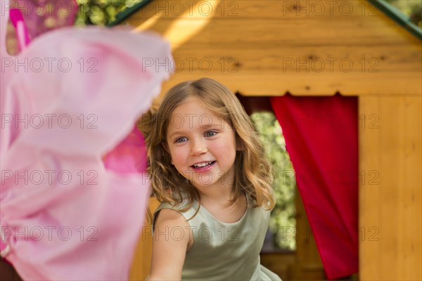 Smiling girl in playhouse