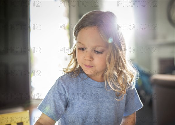 Sun shining behind girl in living room