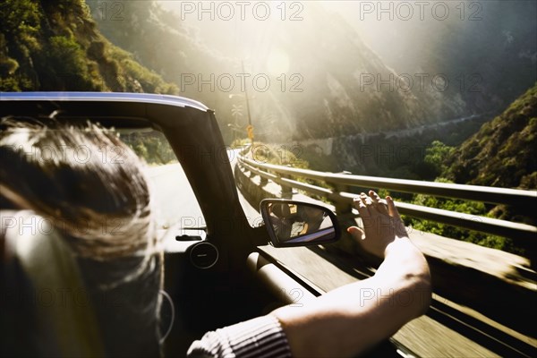 Asian woman in convertible car