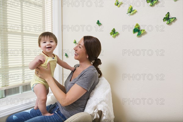 Mixed race mother holding baby daughter