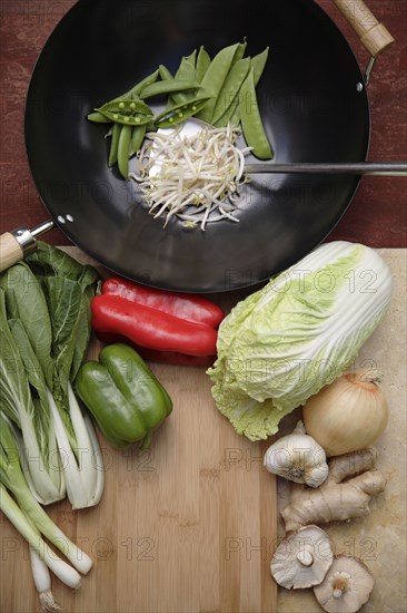 Variety of Asian stir fry ingredients and wok