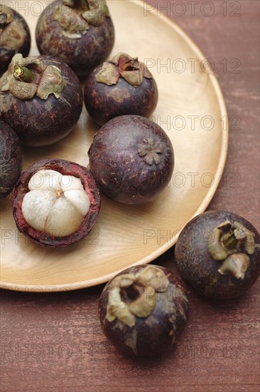 Mangosteen on wooden dish