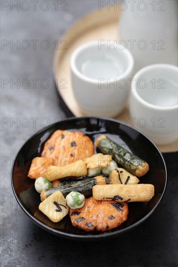 Close up of Japanese rice crackers and sake