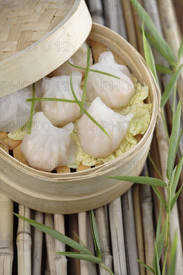 Close up of dim sum dumplings in bamboo basket