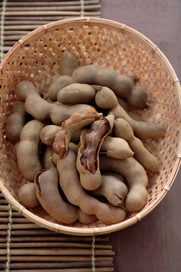 Tamarind pods in wicker basket