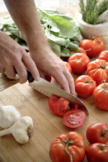Caucasian man chopping tomatoes