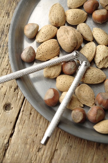 Variety of nuts and nutcracker on platter