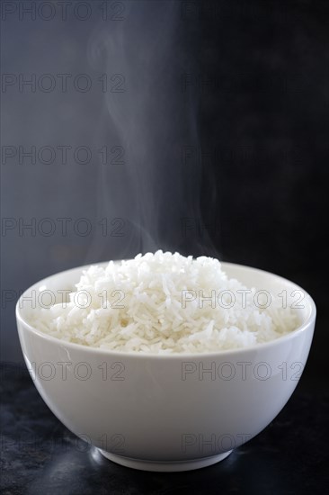 Steaming bowl of cooked rice