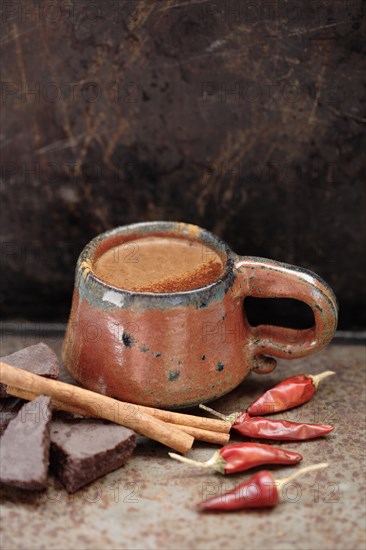 Mexican hot chocolate with cinnamon sticks and chilis