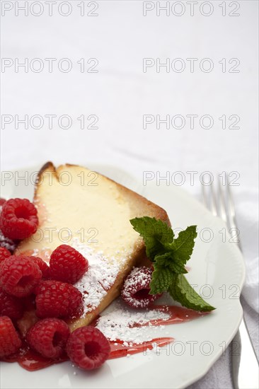 Close up of slice of cake with raspberries