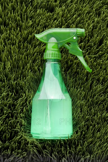 Close up of spray bottle in grass