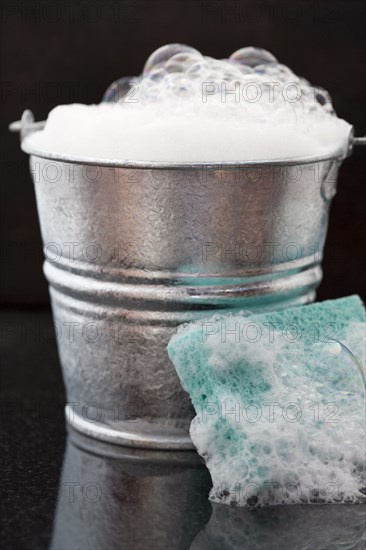 Bucket of soap suds and sponge