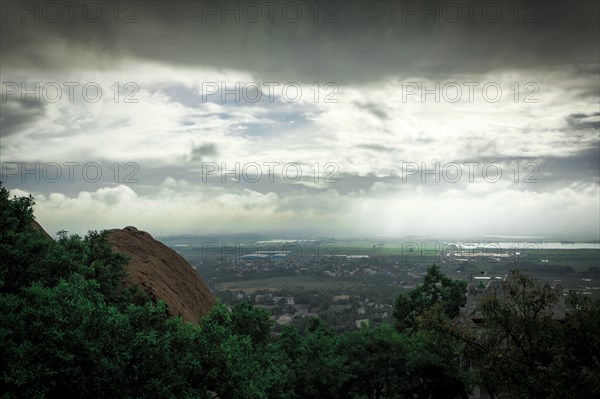 Storm clouds over treetops in rural landscape