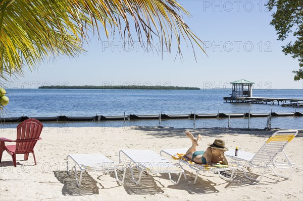Caucasian woman relaxing on tropical beach