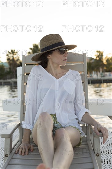 Caucasian woman relaxing in deck chair