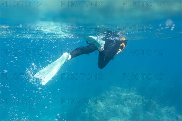 Caucasian woman snorkeling in tropical ocean