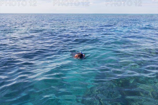 Caucasian woman snorkeling in ocean