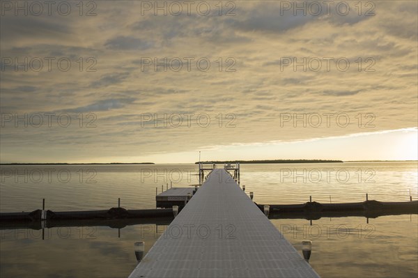 Clouds in sky over pier and ocean