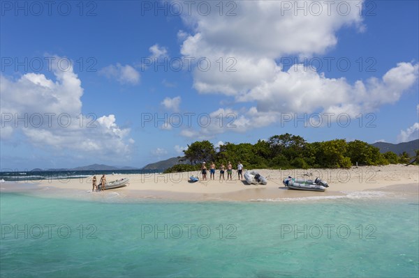 Tourists standing on tropical beach