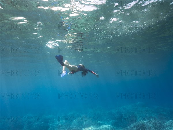 Caucasian woman snorkeling in tropical ocean