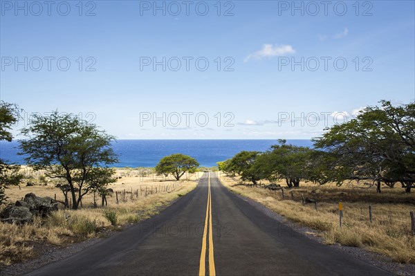 Empty road leading to ocean