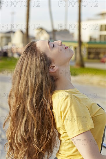Caucasian woman tossing her hair