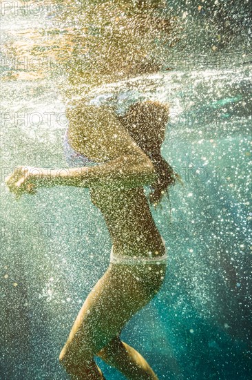 Mixed race woman swimming in ocean