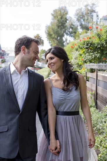 Smiling couple holding hands outdoors