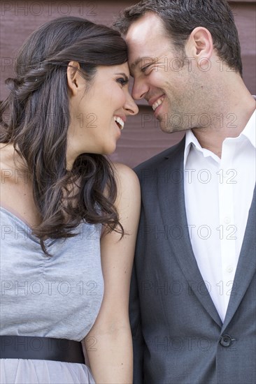 Smiling couple touching foreheads