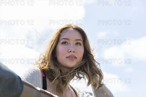 Wind blowing hair of Mixed Race woman