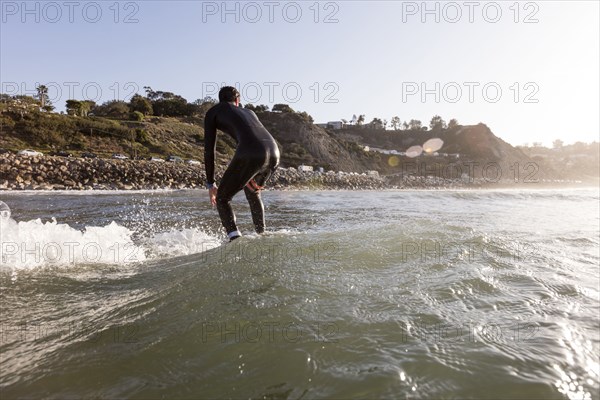 Caucasian man surfing