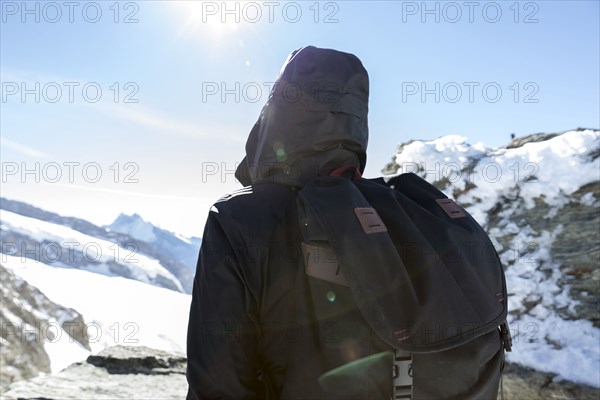 Person wearing backpack in winter landscape