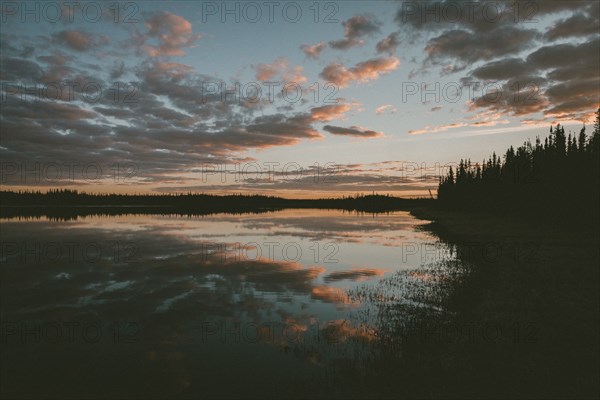 Reflection of clouds in water at sunset