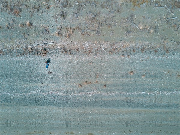 Aerial view of Caucasian woman sitting on beach