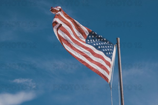 American flag under blue sky