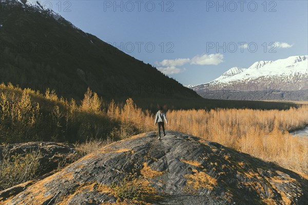 Caucasian woman standing in rock near snowy mountain