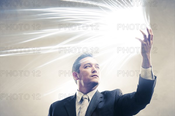 Light radiating from Japanese businessman's hands