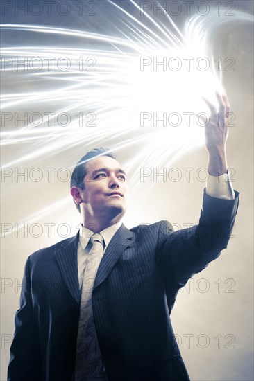 Light radiating from Japanese businessman's hands