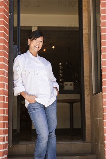 Chinese chef standing in restaurant doorway