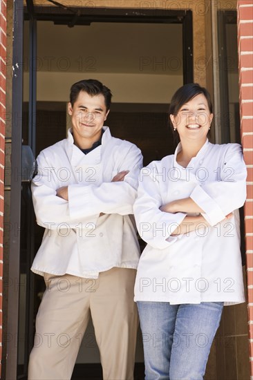 Chinese chefs standing in restaurant doorway
