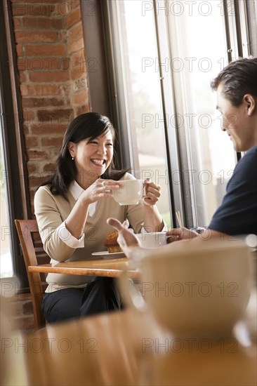 Chinese couple relaxing in cafe