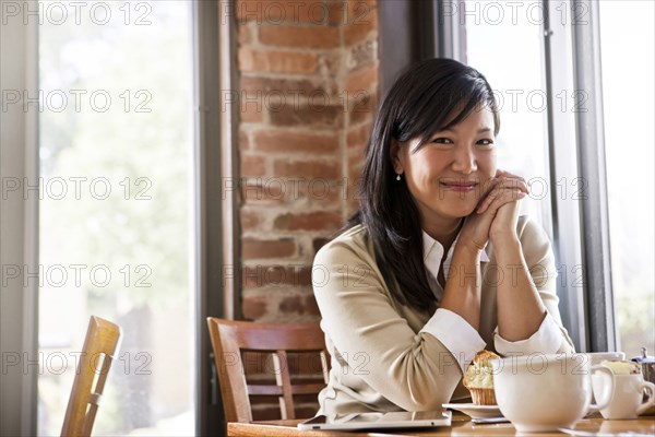 Chinese woman drinking coffee in cafe