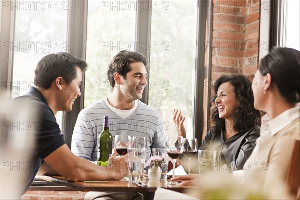 Friends drinking red wine in restaurant