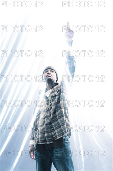 African American man pointing at light spark