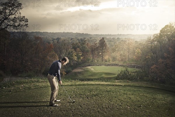 Caucasian man playing golf