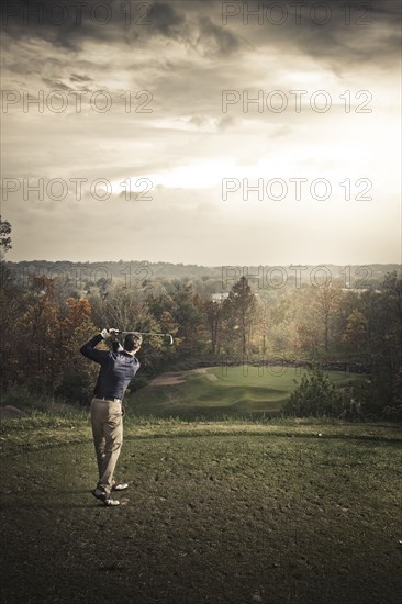 Caucasian man playing golf