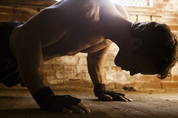 Caucasian man doing push-ups