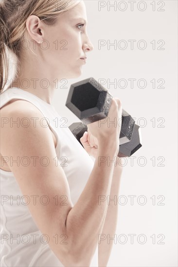 Caucasian woman exercising with dumbbells